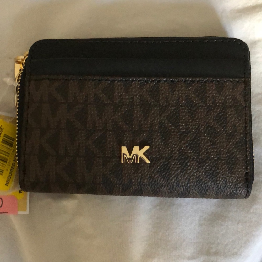 Michael Kors brown logo small zip around wallet.